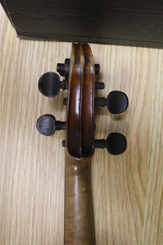 A violin, bow and a mother of pearl inlaid mandolin